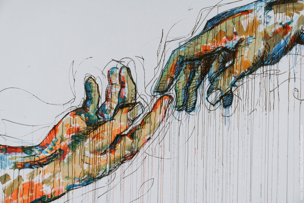 Graffiti: zwei Hände berühren sich fast - frei nach Michelangelo